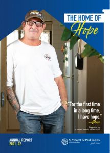 The front cover of Vinnies Queensland's Annual Report, featuring a man in a white shirt posing and the title "The Home of Hope"